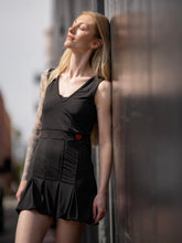 Load image into Gallery viewer, Short Black Angelina Court to Cocktails Tennis Dress. The Angelina Dress is from our sophisticated and elegant collections, for women with a flair for looking good. Our dress is fitted through the bodice, and flares out at the skirt. It is perfect for tennis, running and golf, and of course, a trip to your after-court party with your friends. It was designed for confident women like you!   Wear this stunning piece straight from the court to cocktails.