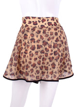 Load image into Gallery viewer, This limited Leopard Mesh LOVE "O" Skirt has shorties underneath and NO seams on the "O"! It's cut like a doughnut to show and move beautifully as you play. The fabric is uber soft and light - it dries quickly - and protects from UV rays too. This skirt has a “nearly naked” feel about it. Sleek black thread and binding.