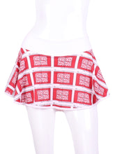 Load image into Gallery viewer, This gorgeous mini heart on white LOVE "O" Skirt has shorties underneath and NO seams on the "O"!  It's cut like a doughnut to show and move beautifully as you play.  The fabric is uber soft and light - it dries quickly - and protects from UV rays too.  This skirt has a “nearly naked” feel about it.