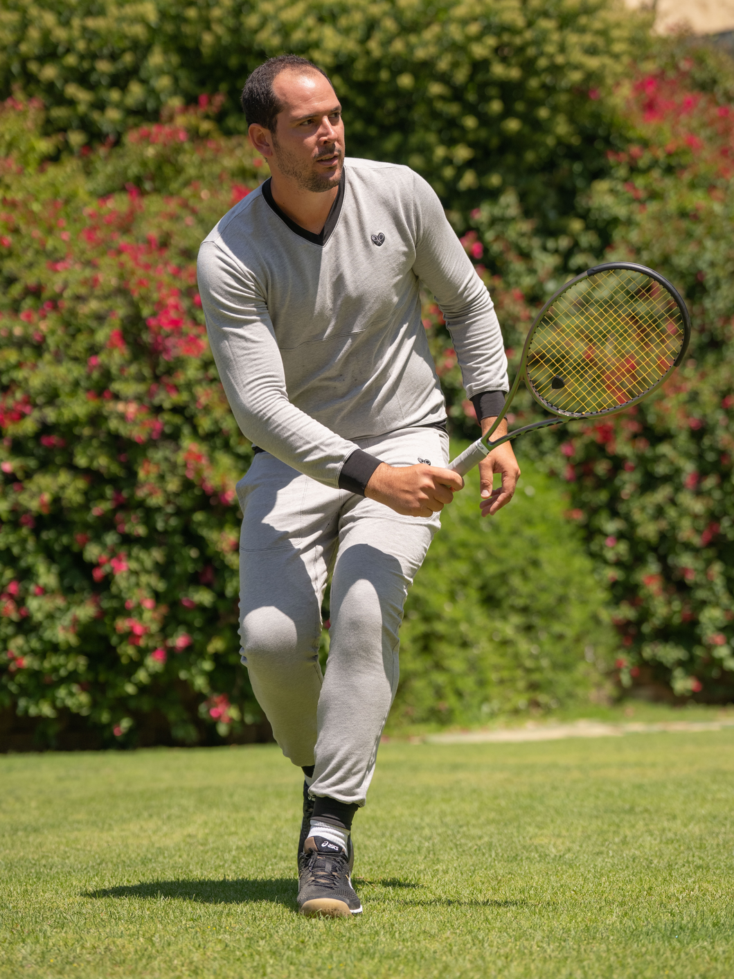 The Limited French Terry V-Neck Long Sleeve Black Tennis Shirt by Love Love Tennis is a premium sportswear piece that seamlessly combines style, comfort, and performance.