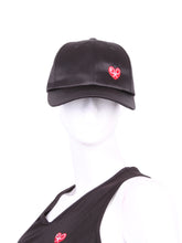 Load image into Gallery viewer, The Soft Satin Black Tennis Hat is a stylish and functional accessory designed for tennis enthusiasts. Crafted from a smooth satin material, this hat offers a comfortable and lightweight feel. Its sleek black color adds a touch of sophistication to your tennis attire, while the soft texture ensures a pleasant wearing experience.

