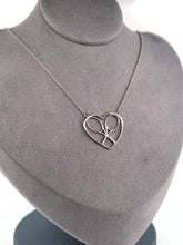 Load and play video in Gallery viewer, For the true tennis lover - a custom made heart with joint rackets - the logo of the Love Love Tennis brand.  This necklace is made in downtown Los Angeles and the exclusive design by Adeline - and a commitment to the love of tennis.  Each piece is hand cast in solid 14k gold, polished and sent with love.
