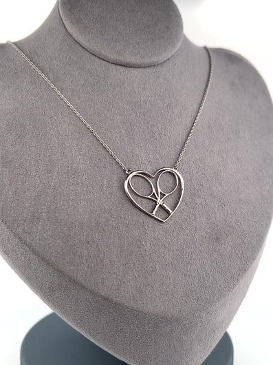 For the true tennis lover - a custom made heart with joint rackets - the logo of the Love Love Tennis brand.  This necklace is made in downtown Los Angeles and the exclusive design by Adeline - and a commitment to the love of tennis.  Each piece is hand cast in solid 14k gold, polished and sent with love.