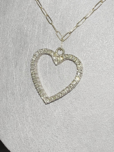 This luxurious necklace features a 1 inch gold heart covered in diamonds totalling over 1 karat. Displays beautifully on an elegant solid gold paper clip chain. By LOVE LOVE TENNIS