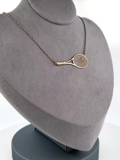 Diamond Tennis Ball Necklace Although delicate in looks - this necklace is light but strong!  Each string is defined just like a racket - and the diamond ball shines brightly.  Every piece is lovingly made in Los Angeles - and they are my exclusive design.  Available in yellow or white gold - this choker is the best seller of all of my fine tennis jewel collection.
