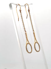 Load and play video in Gallery viewer, Custom exclusive design by Adeline a very unique pair of earrings.   The rackets are 1&quot; long and the earrings sit 2 1/2&quot; down.  The racket and hook are solid gold and adorned with many beautiful clear diamonds to make you &quot;shine&quot; on the court.  Very strong yet light enough to play in!
