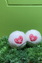 Load image into Gallery viewer, The cutest tennis balls ever.   The pressured white balls are handmade in Bath, England (where Adeline the designer was actually born) - and bear the LOVE LOVE TENNIS trademark Heart + Rackets Logo.
