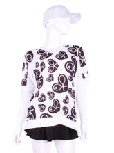 Load image into Gallery viewer, Random Black Heart Baggy Vee Tee The very comfortable Baggy Vee Tee is so cool and easy to wear.  For the lady that likes a little room when she plays - the feminine top is flowing in the air.  This random black heart on a white background has a white stripe down the sides, hem, collar, and cuff.
