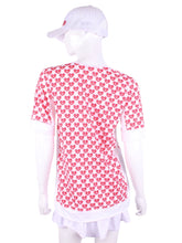 Load image into Gallery viewer,  The very comfortable Baggy Vee Tee is so cool and easy to wear.  For the lady that likes a little room when she plays - the feminine top is flowing in the air.  This Mini Hearts on a white background has a white stripe down the sides, hem, collar, and cuff.
